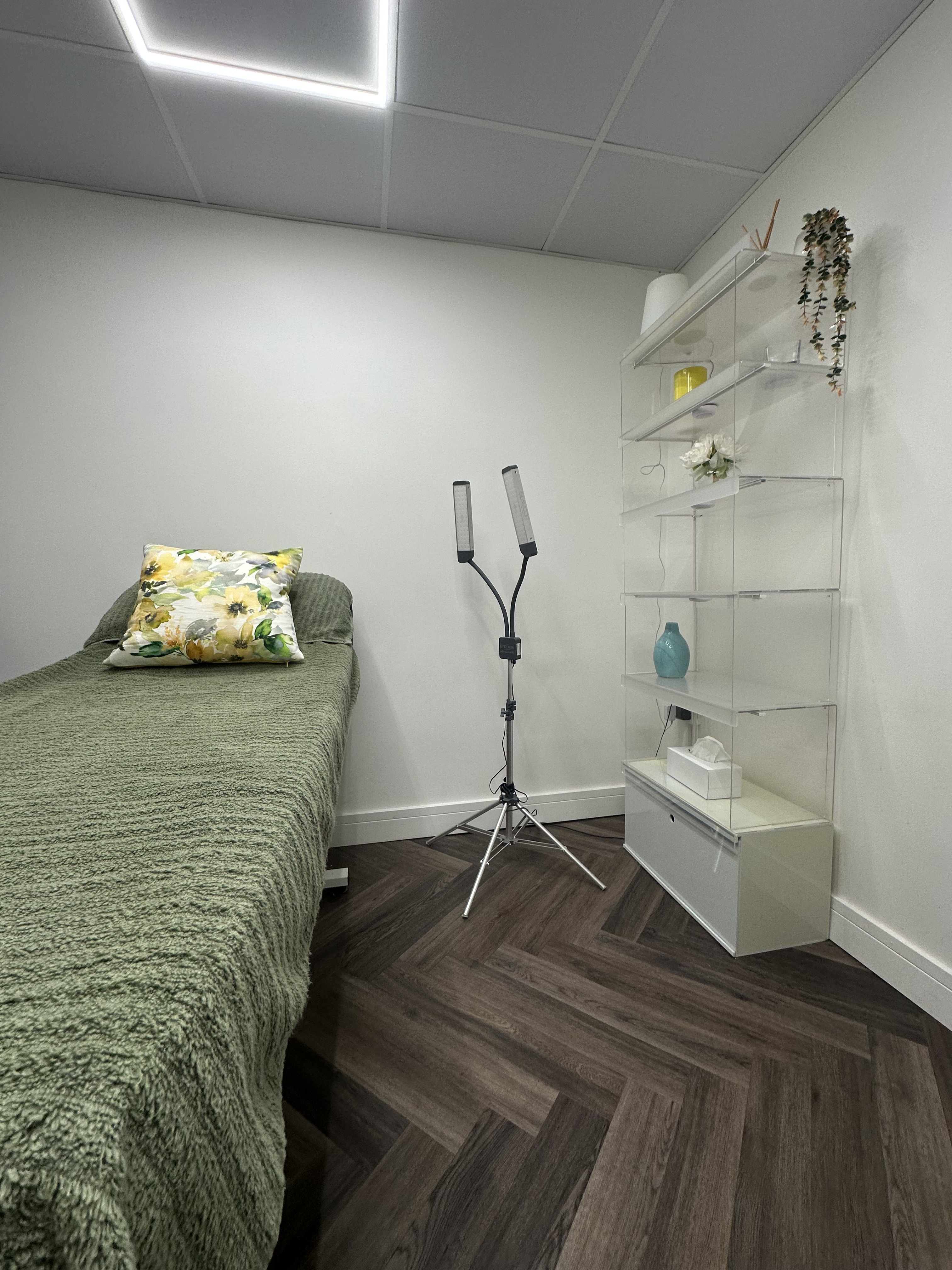 Treatment bed with sage throw and floral cushion at Radiant by Fran